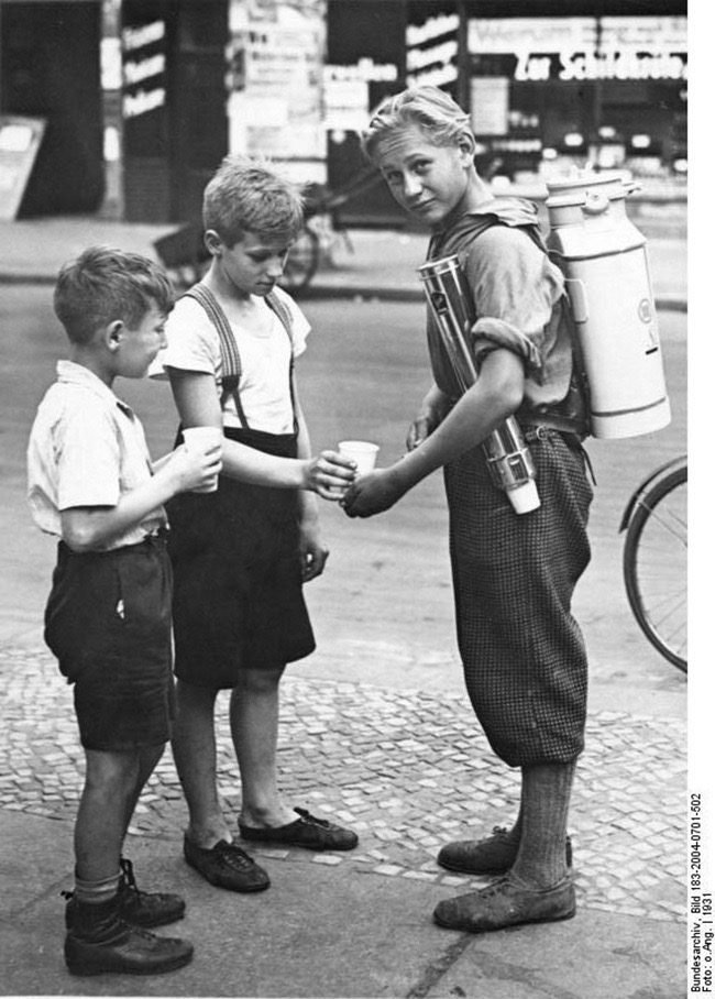 A boy selling lemonade with a portable lemonade dispenser, Berlin, 1931